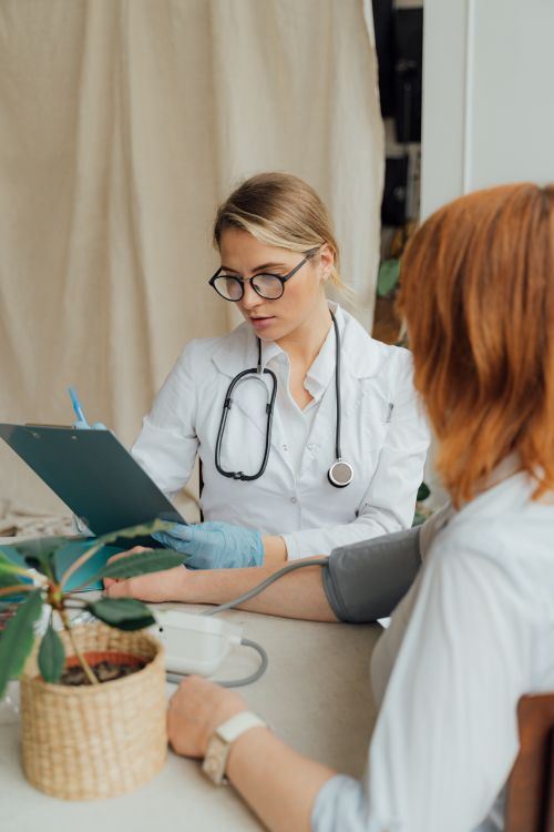 A patient talking with her doctor during a blood pressure check