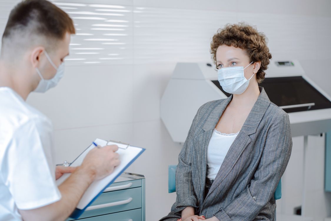 A doctor and patient discussing care in a consultation room